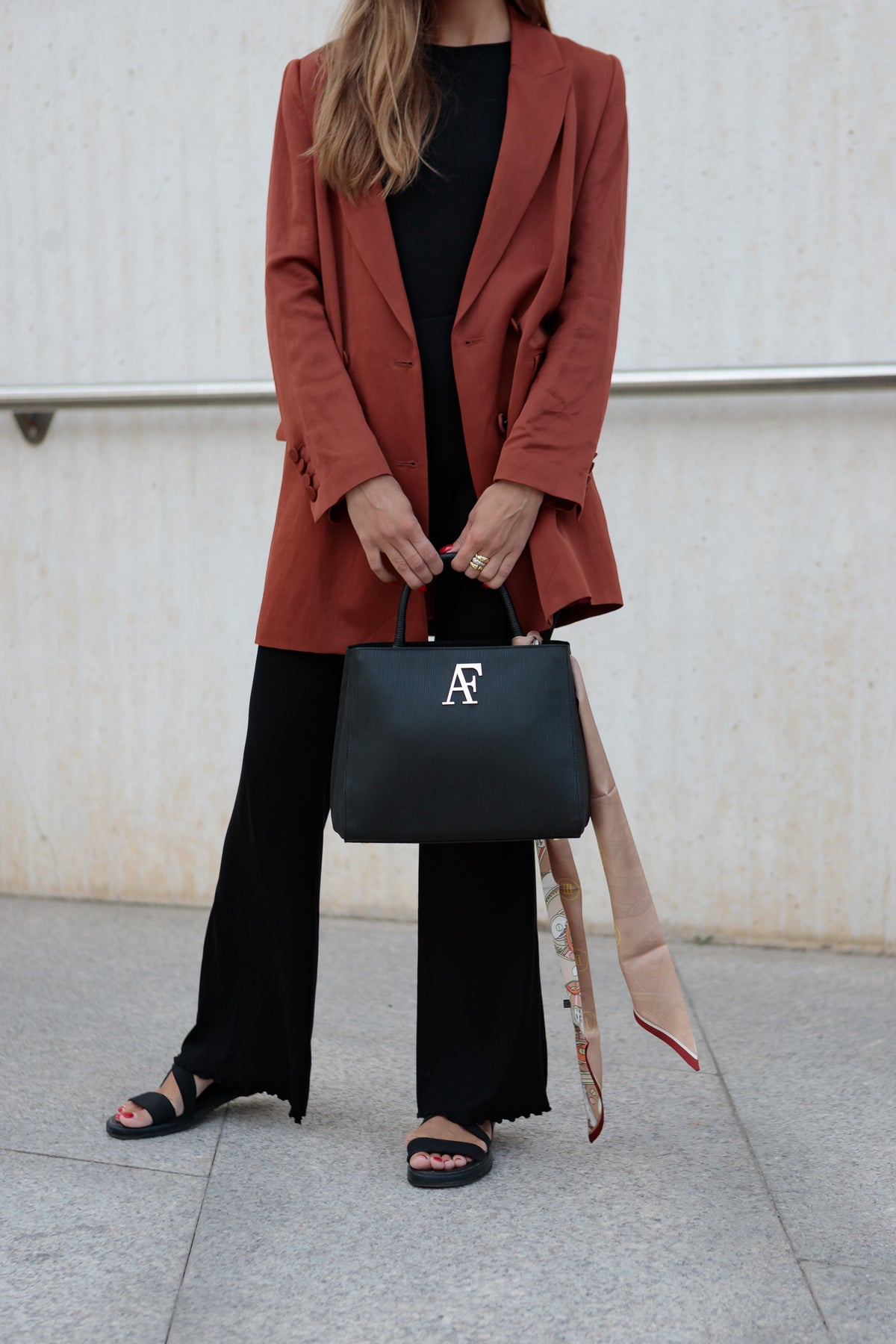 Navona, top-handle bag in black textured Italian leather – carried by hand