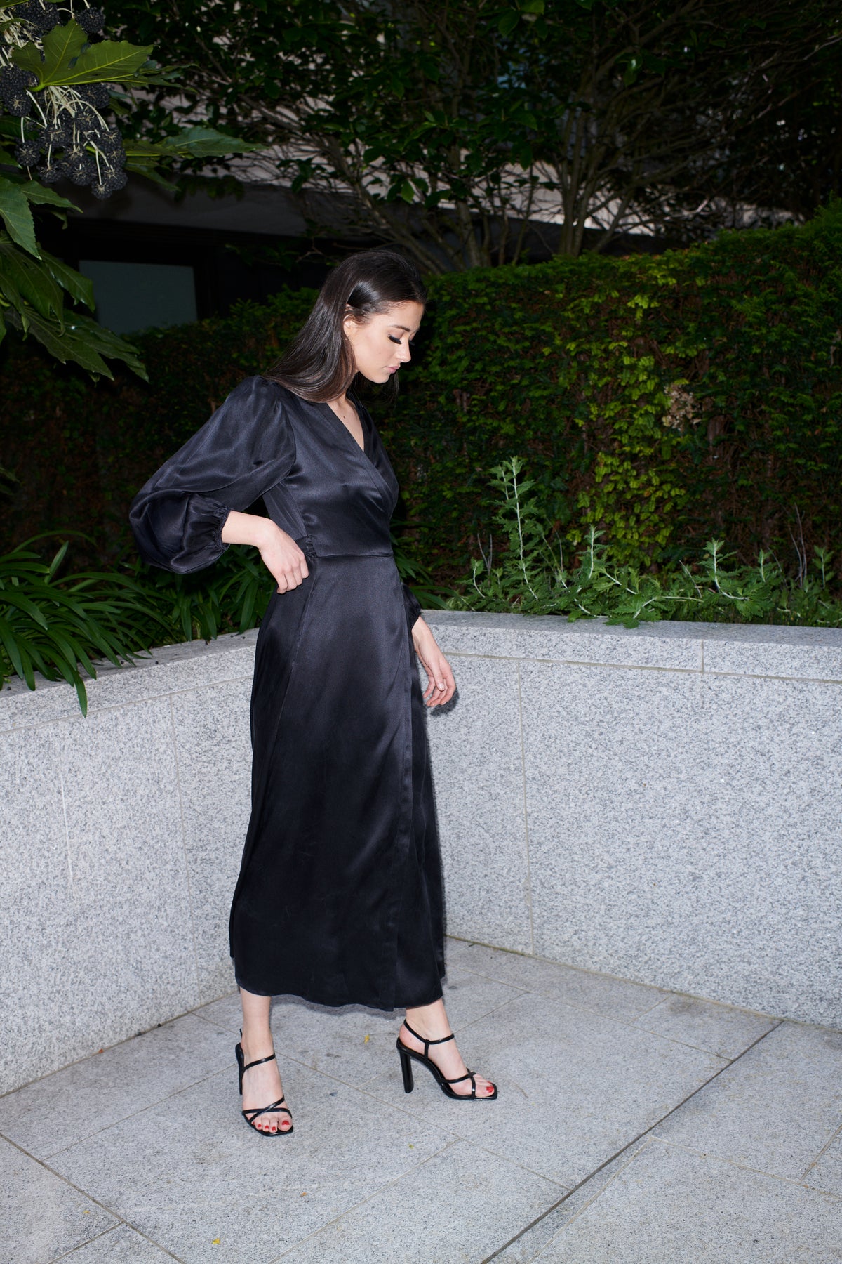Beatrice, wrap dress in black 100% Mulberry silk – on model – Alinari Firenze