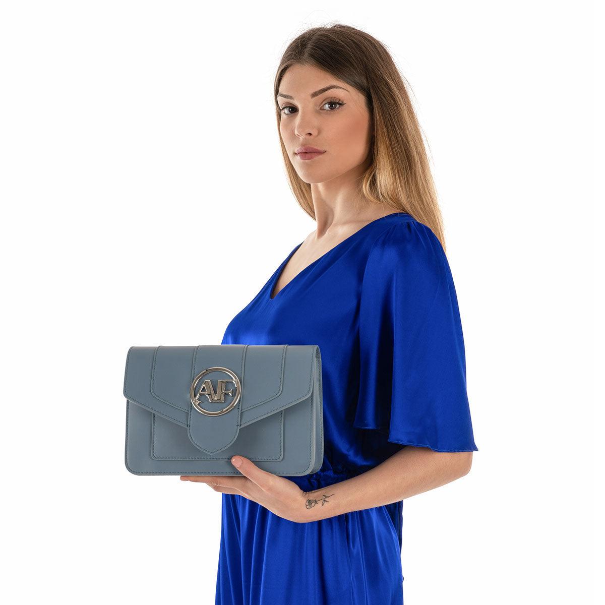 Brera, crossbody bag in blue smooth Italian Ruga leather – carried by hand