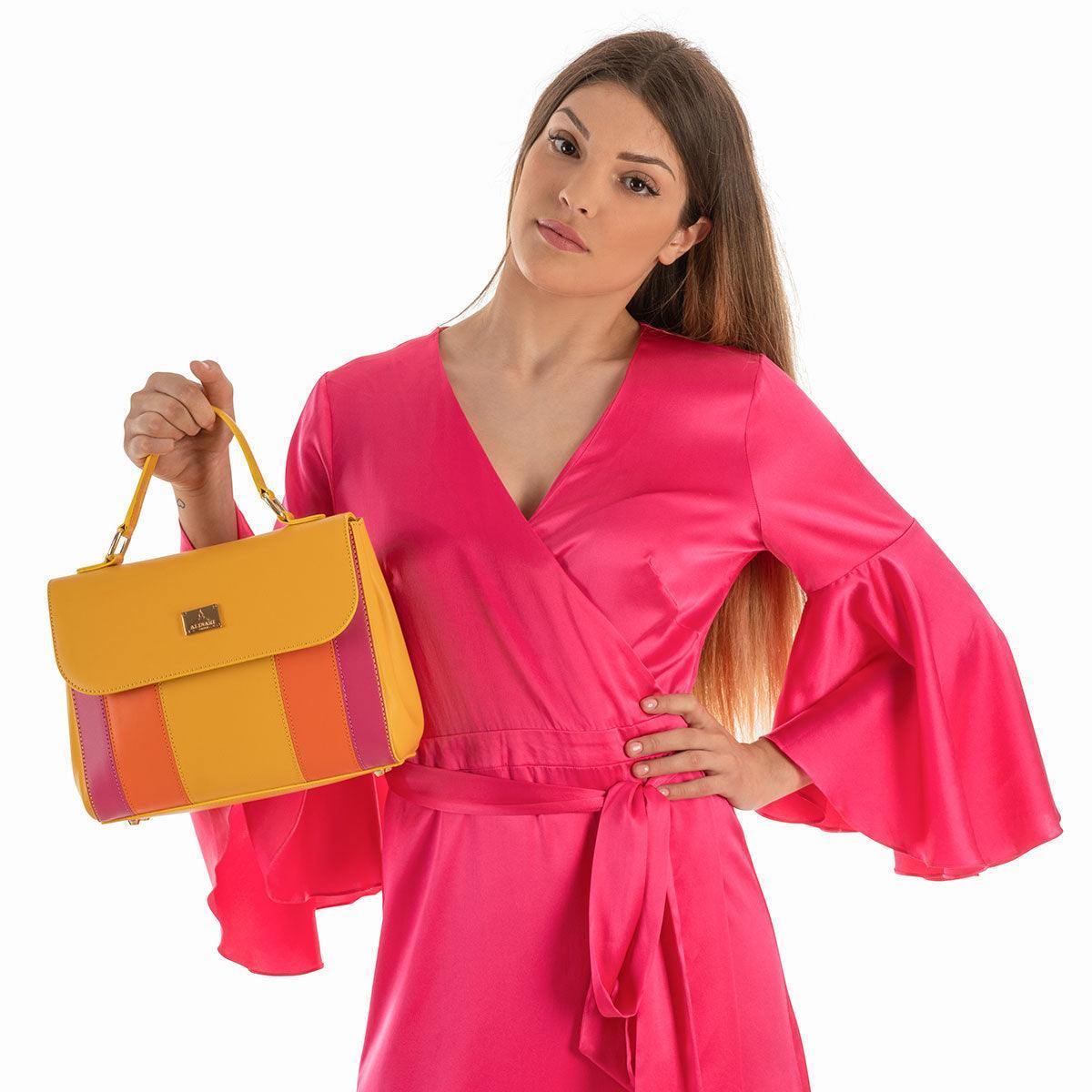 Trevi, top-handle handbag in yellow Italian Ruga leather with striped panels – carried by hand