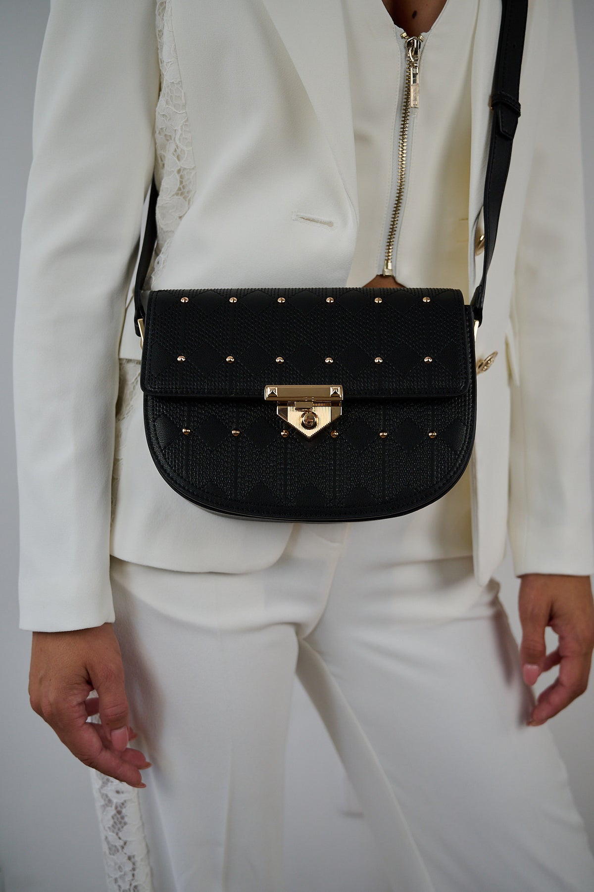 Naelie, crossbody bag in black diamond-quilted Italian leather with gold studs – worn crossbody