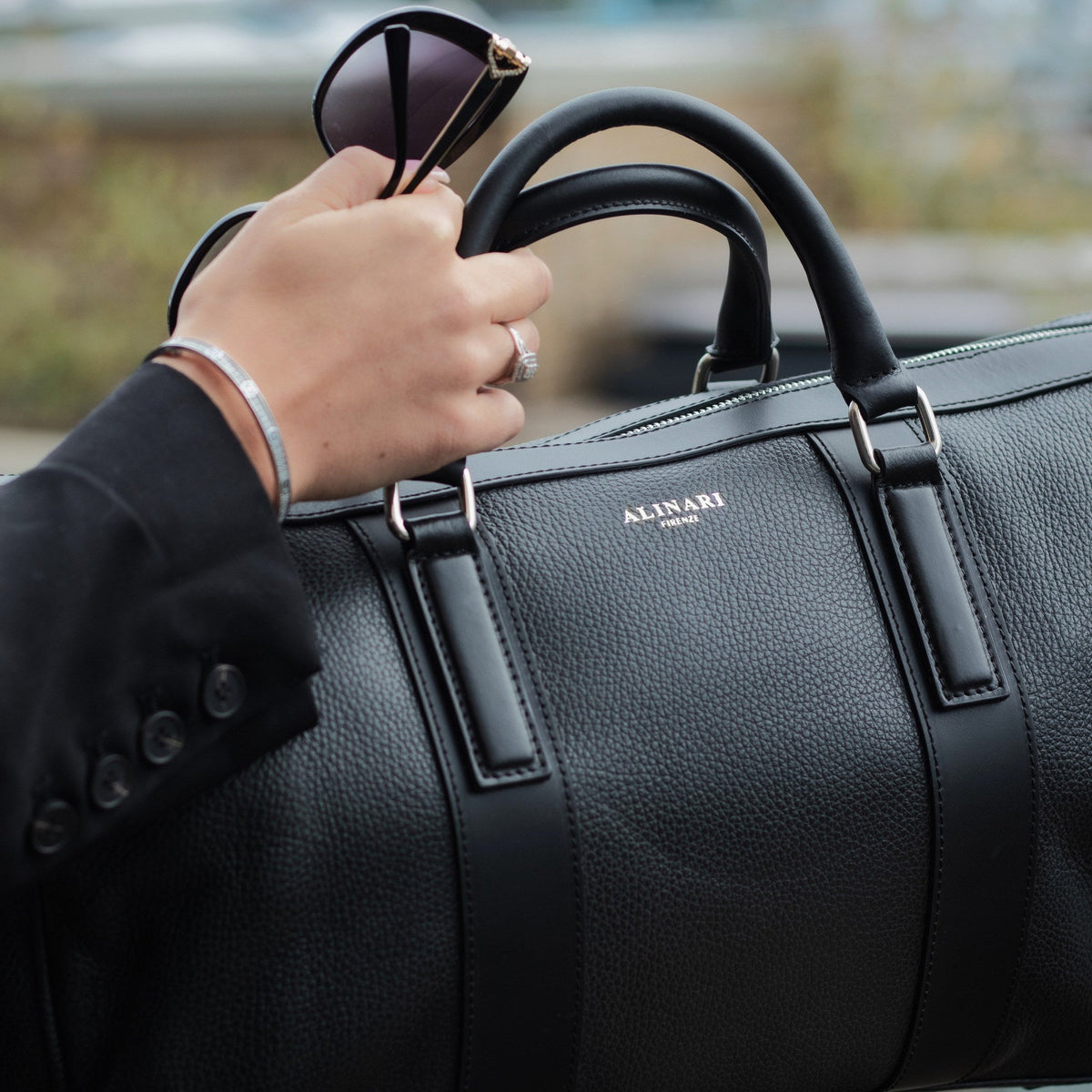 Milano travel bag in black Italian calfskin, held by its top handles
