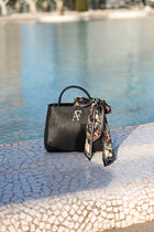 Navona, top-handle bag in black textured Italian leather – styled photo