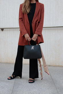 Navona, top-handle bag in black textured Italian leather – carried by hand