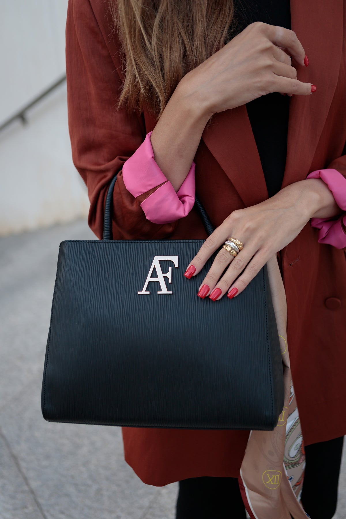Navona, top-handle bag in black textured Italian leather – carried by hand