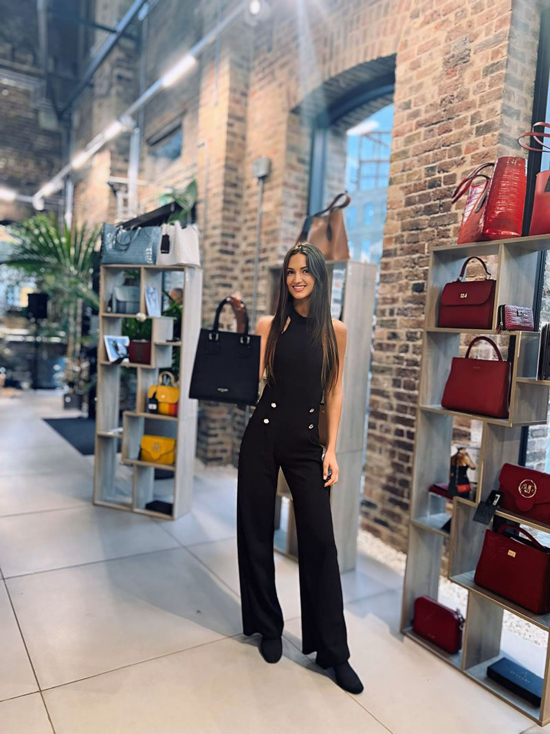 Woman in black among shelves of Italian leather handbags