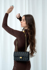 An Alba Shoulder Crossbody with studs and a chain, made of Italian leather, by Alinarifirenze.