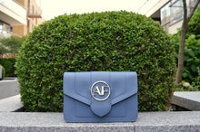 Brera, crossbody bag in blue smooth Italian Ruga leather – front view outdoors in daylight