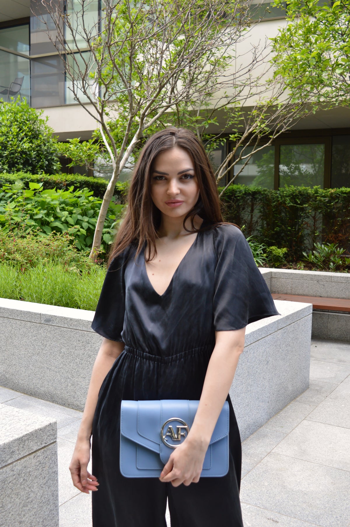 Brera, crossbody bag in blue smooth Italian Ruga leather – carried by hand, styled with the Vittoria Silk Jumpsuit