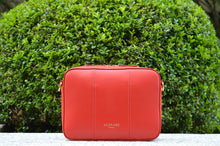 Flavia, crossbody bag in red Italian Ruga leather – front view outdoors in daylight