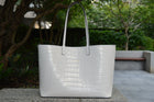 Maxima Croco Tote, laptop tote in white croc-embossed Italian leather – front view outdoors in daylight