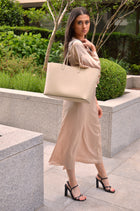 Maxima Tote, laptop tote in beige smooth Italian leather – worn on the shoulder