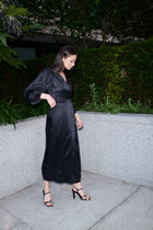 Beatrice, wrap dress in black 100% Mulberry silk – on model – Alinari Firenze