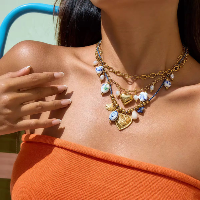 Blue and Gold Charm, layered necklace set in gold-plated alloy and ceramic beads – styled view – Alinari Firenze