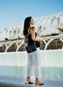 Flavia, crossbody bag in black Italian Ruga leather – worn crossbody