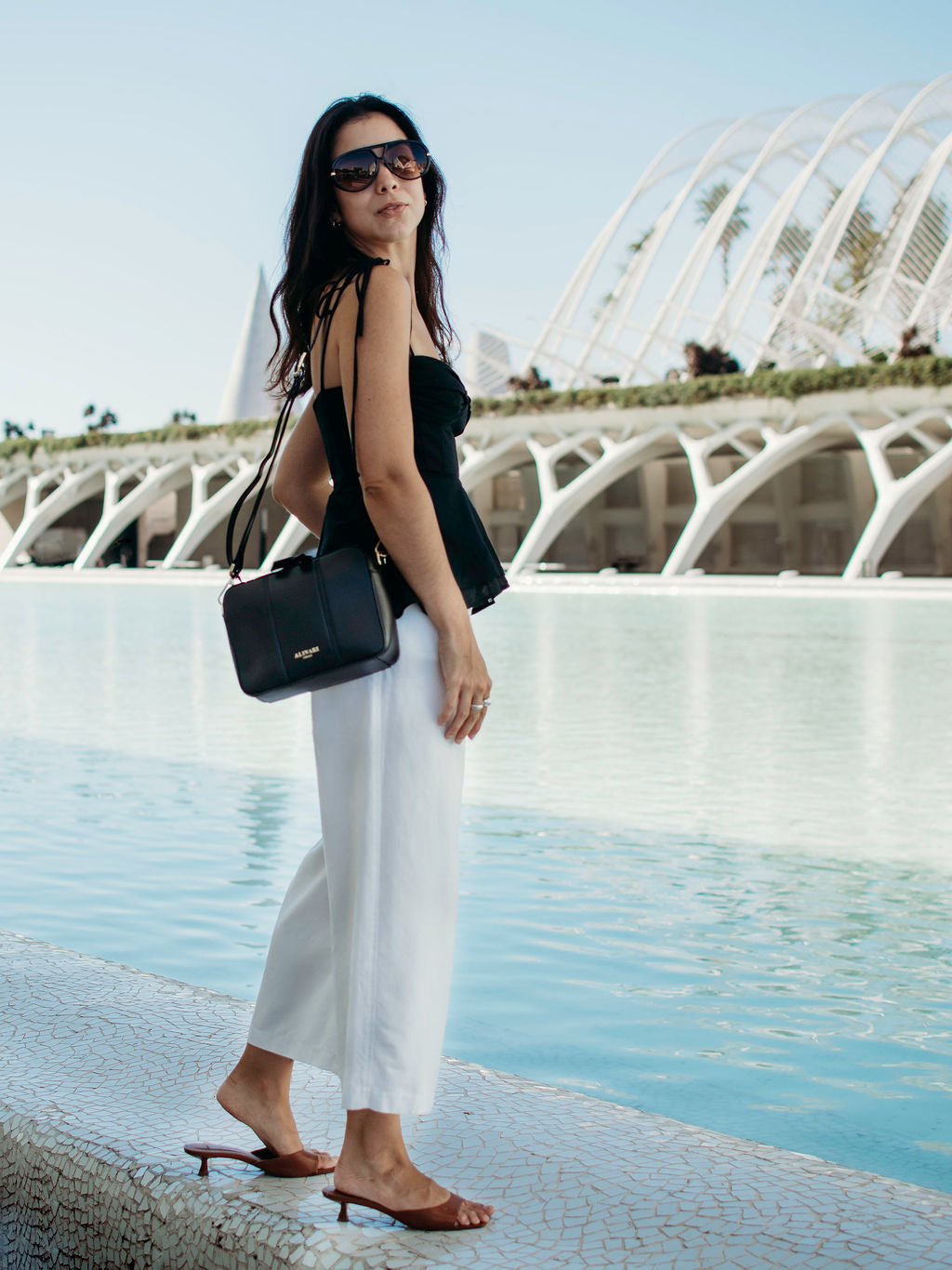 Flavia, crossbody bag in black Italian Ruga leather – worn crossbody