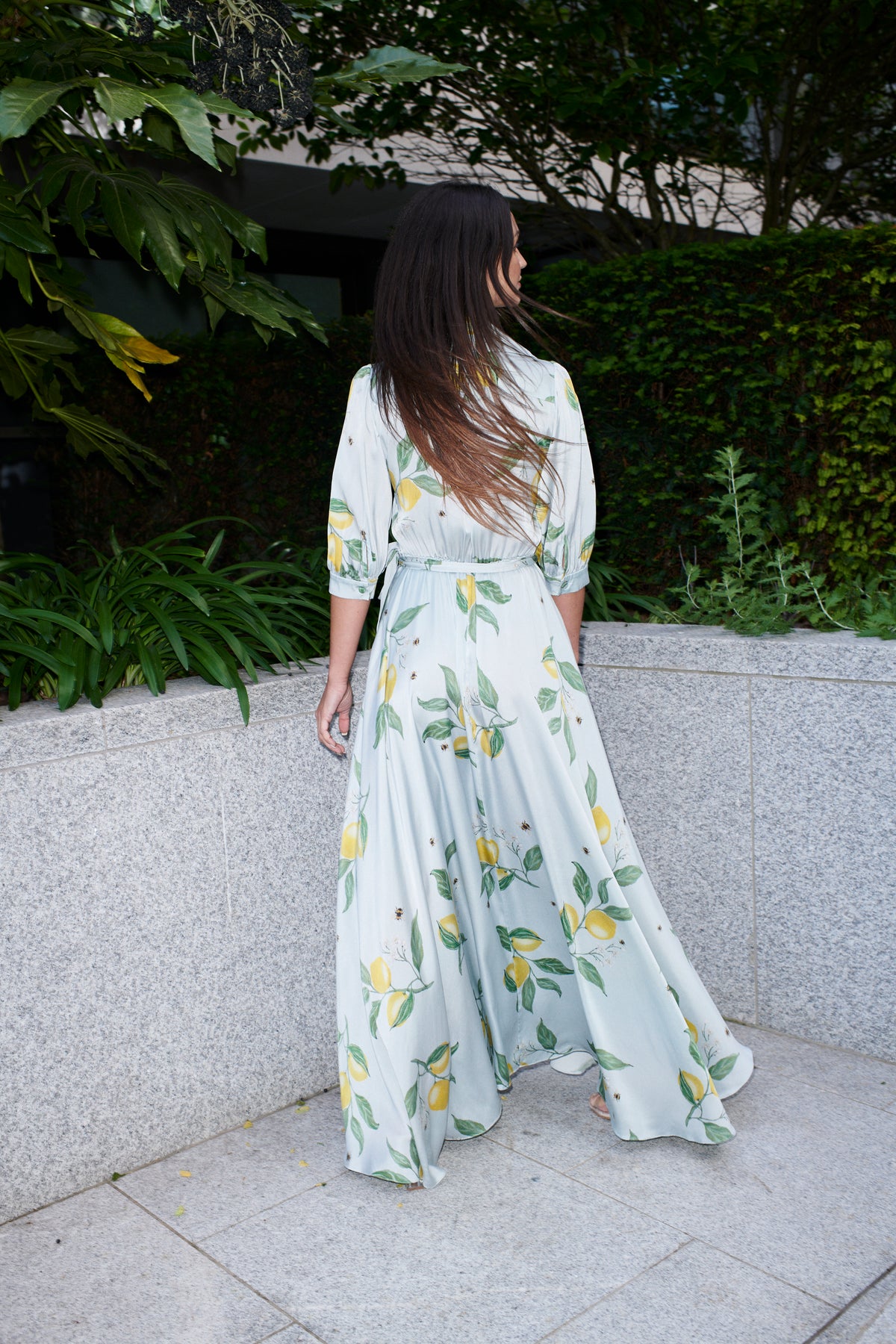 Giulia, silk wrap dress in lemon-print 100% Mulberry silk – on model 3 – Alinari Firenze