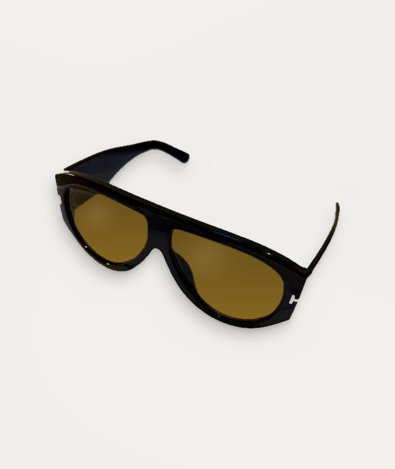 Modena, sunglasses in black with amber-tint lenses, UV400 protection – product view on cream – Alinari Firenze