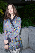 Ornella, wrap blouse in grey-blue hummingbird-print 100% Mulberry silk – on model – Alinari Firenze