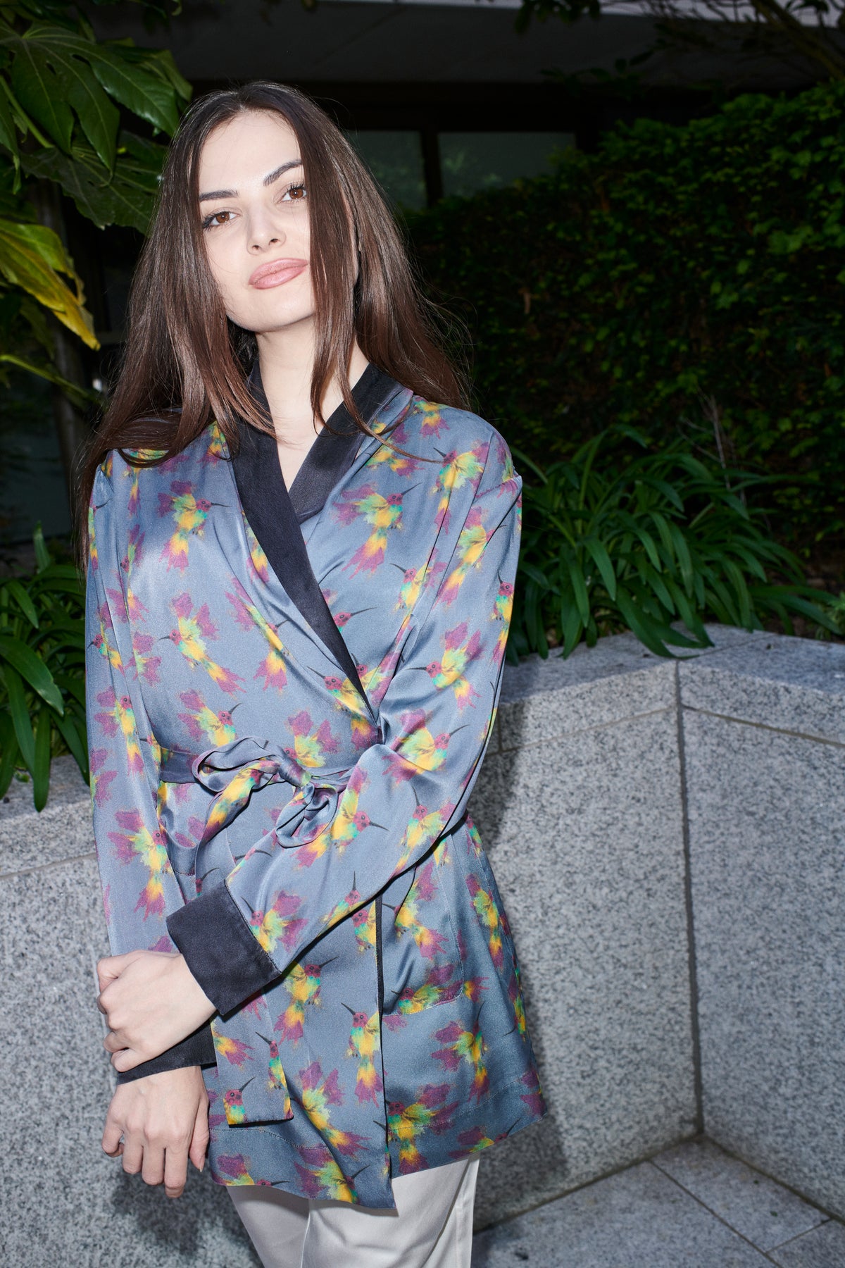 Ornella, wrap blouse in grey-blue hummingbird-print 100% Mulberry silk – on model – Alinari Firenze