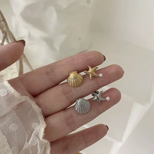 Sea Star and Shell, stud earrings in gold and silver pearl-accent – styled view – Alinari Firenze