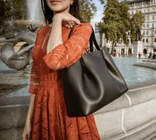 Viviene Tote, slim tote in black Italian Ruga leather – worn on the shoulder